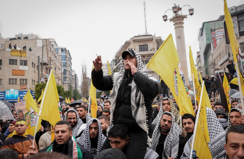 Supporters of the Palestinian Fatah movement gather with flags for a rally ahead of the sixtieth anniversary of its establishment in the city of Ramallah in the West Bank on December 31, 2024. (credit: FLASH90)