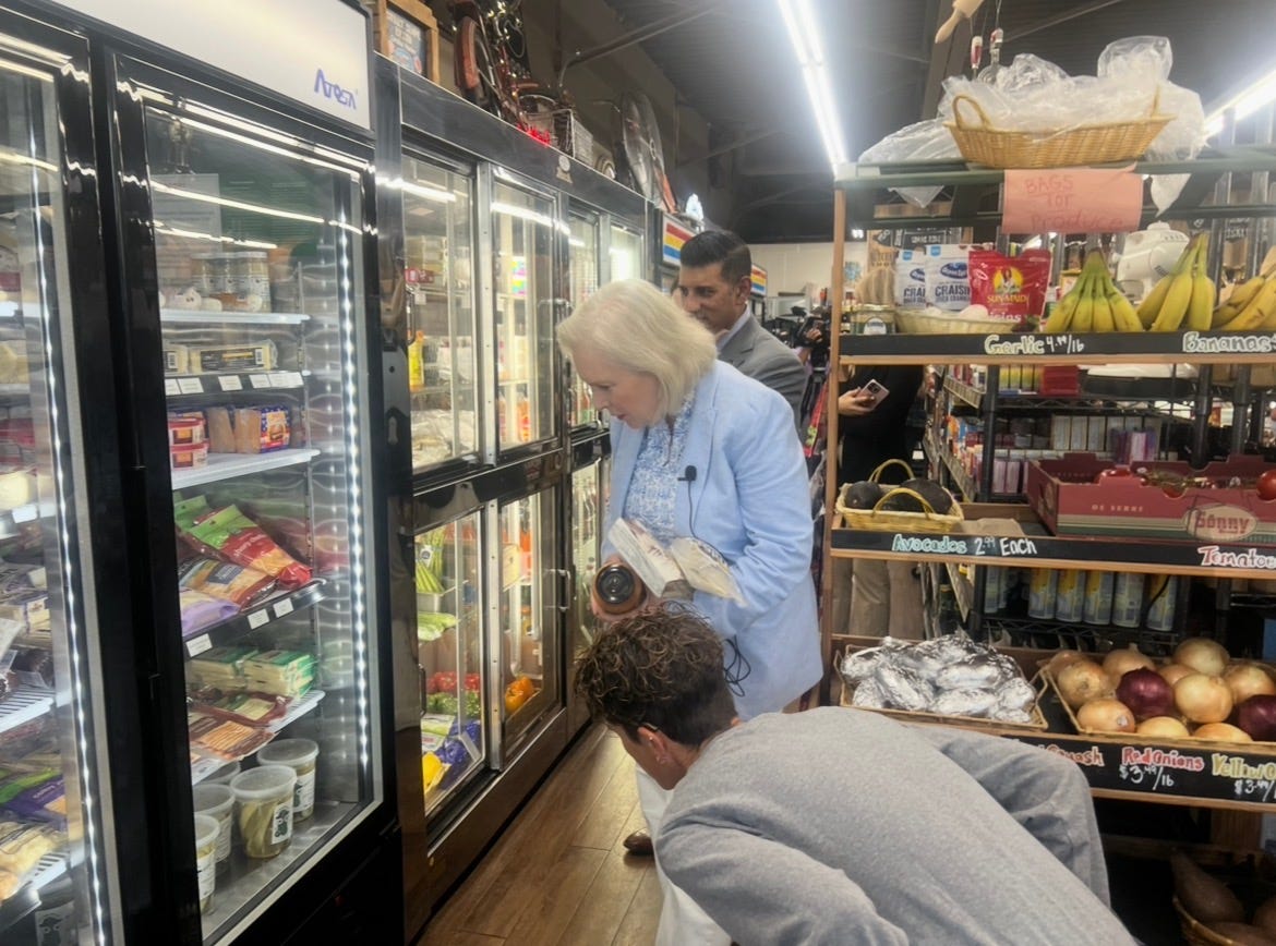 Sen. Gillibrand buys local products from R's Market with state Sen. Cooney and Cooney and Cocca after addressing how the rising costs of groceries is impacting working families.