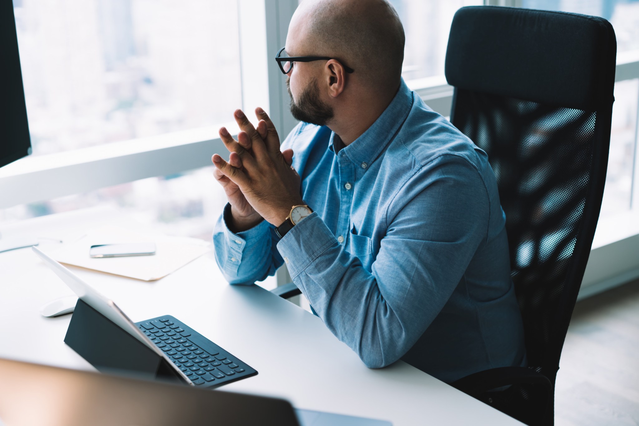 Thoughtful businessman sitting at desk
