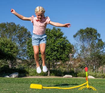 a model jumping on a rocket launcher toy