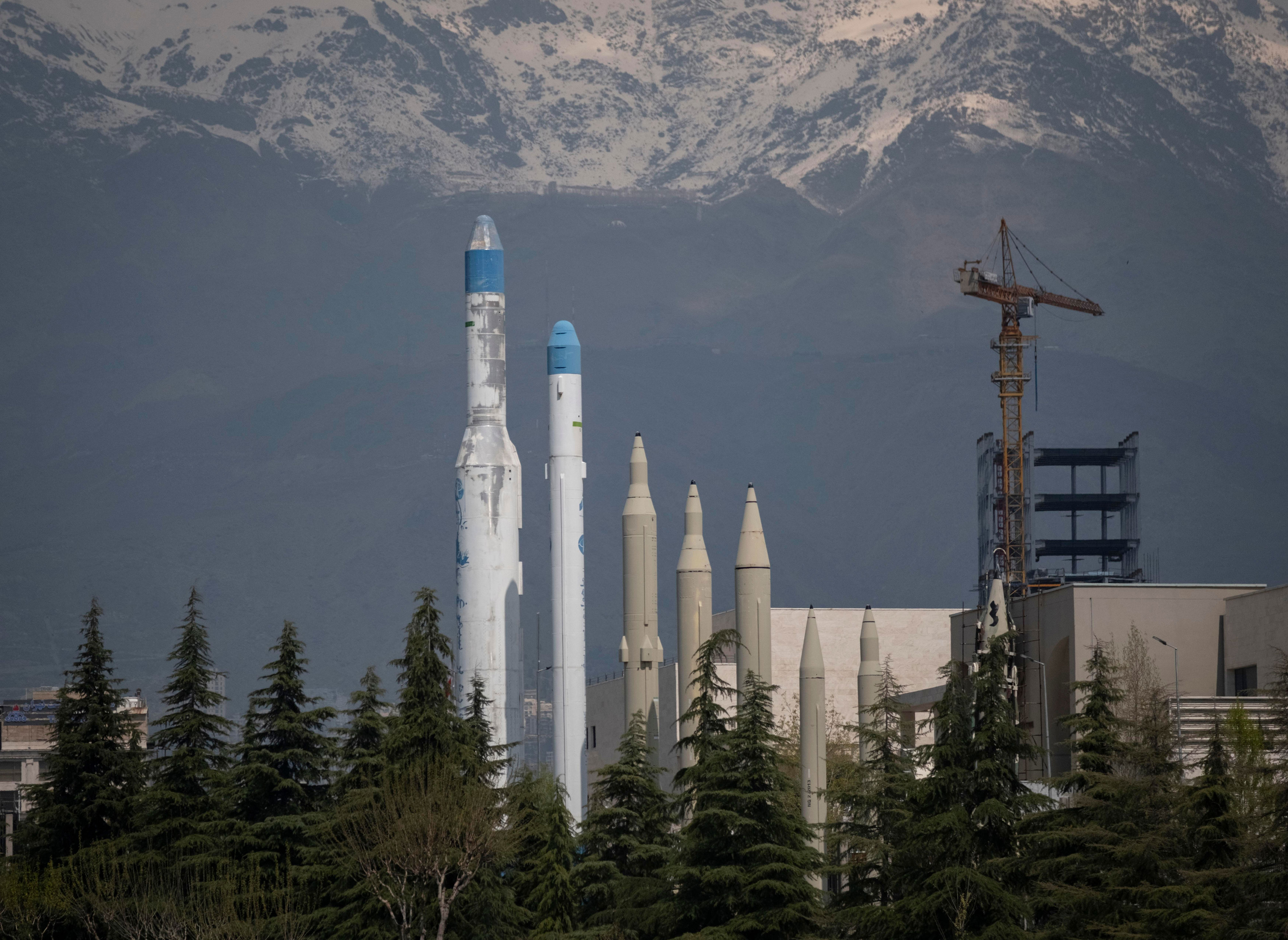 Iranian missiles in front of a mountain backdrop.