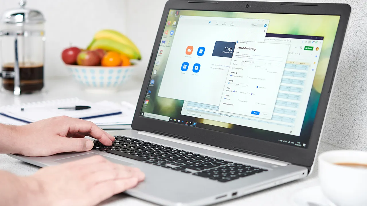 Person typing on their laptop.