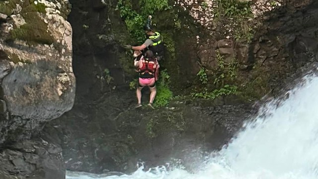 Dog is swept over an 80-foot waterfall in New York, then woman who swam after it gets stuck too
