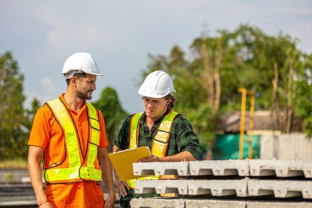 Construction workers review plans on site.