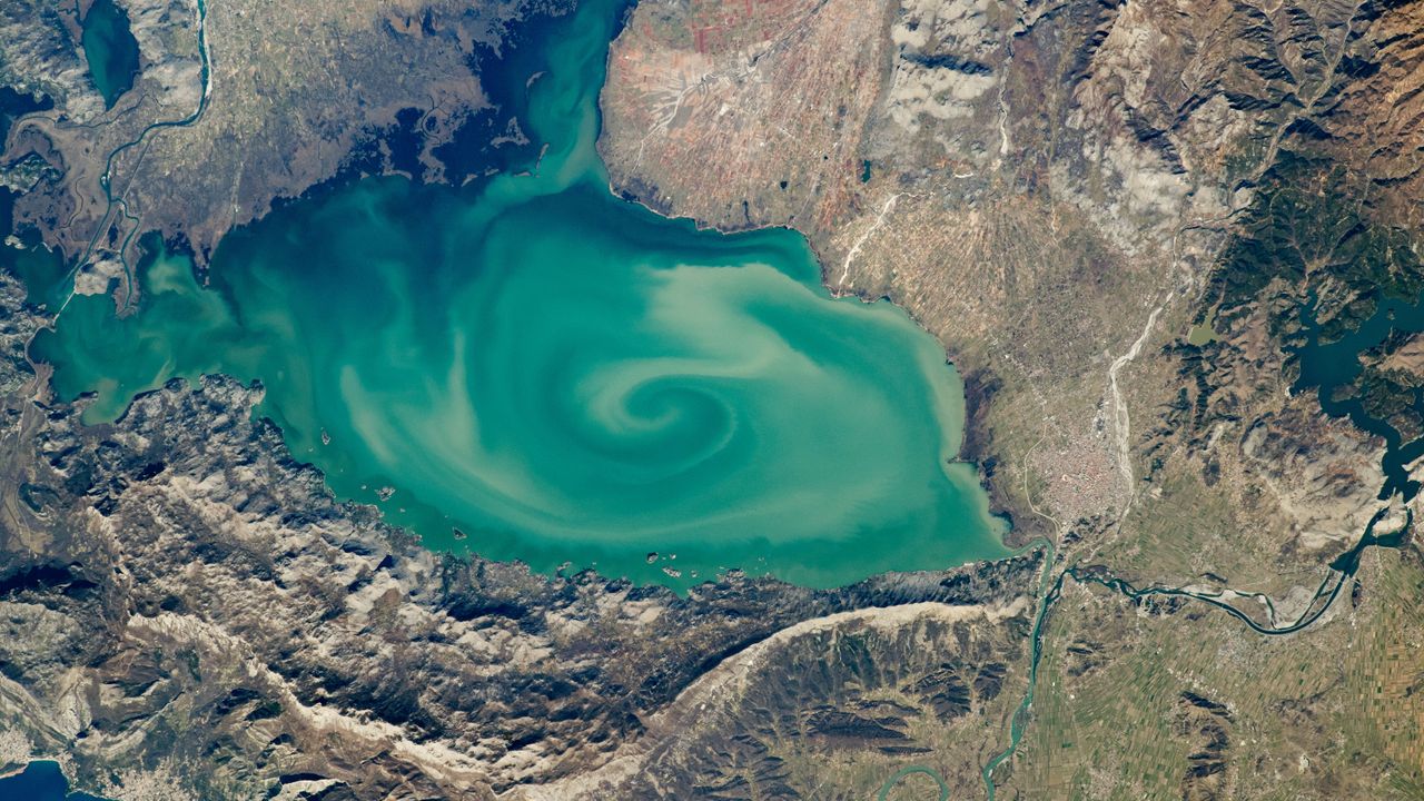 Milky-green vortex swirls across 'cryptodepression' lake in Southern Europe — Earth from space