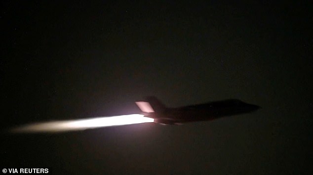 A US military aircraft flies at an unknown location, during what US Central Command (CENTCOM) says are strikes on Iran, in this screengrab taken from a handout video released on July 20