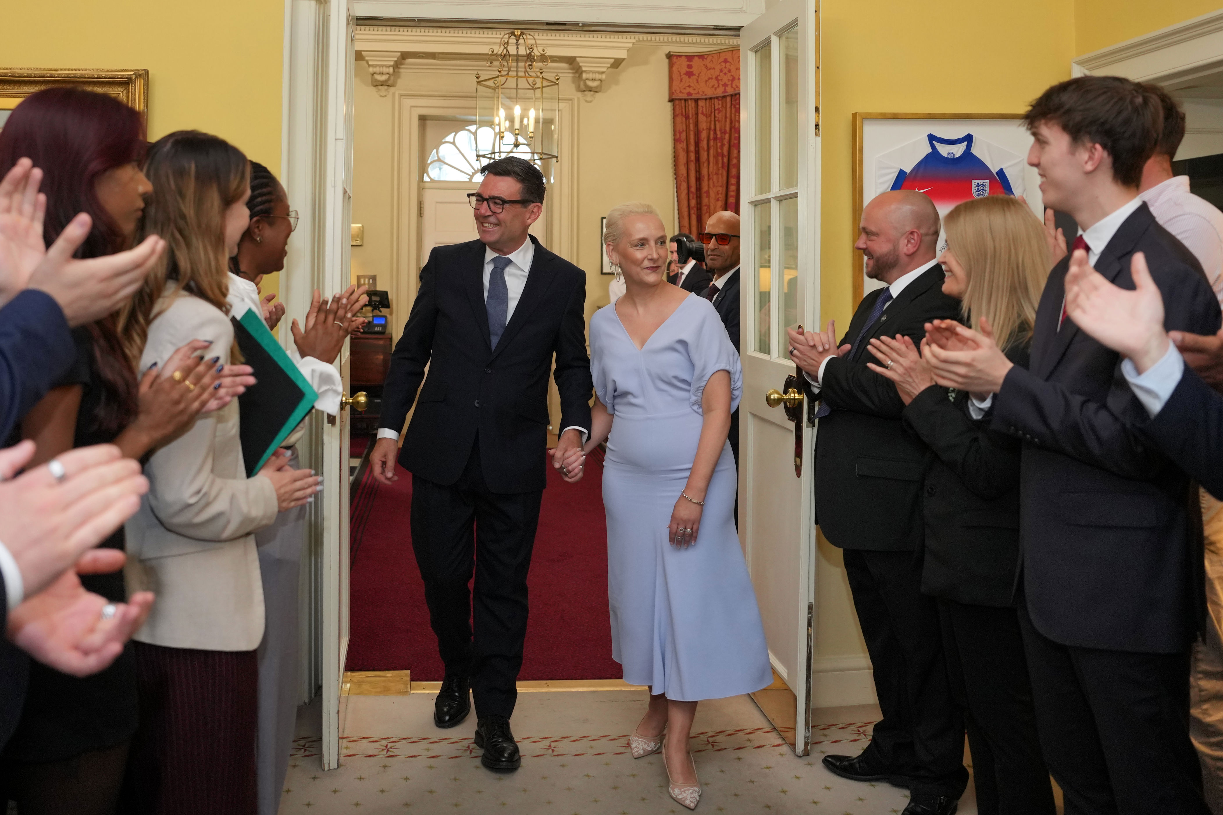 Prime Minister Andy Burnham and his wife, Marie-France van Heel, were greeted by staff as they walked into 10 Downing Street (PA Wire)
