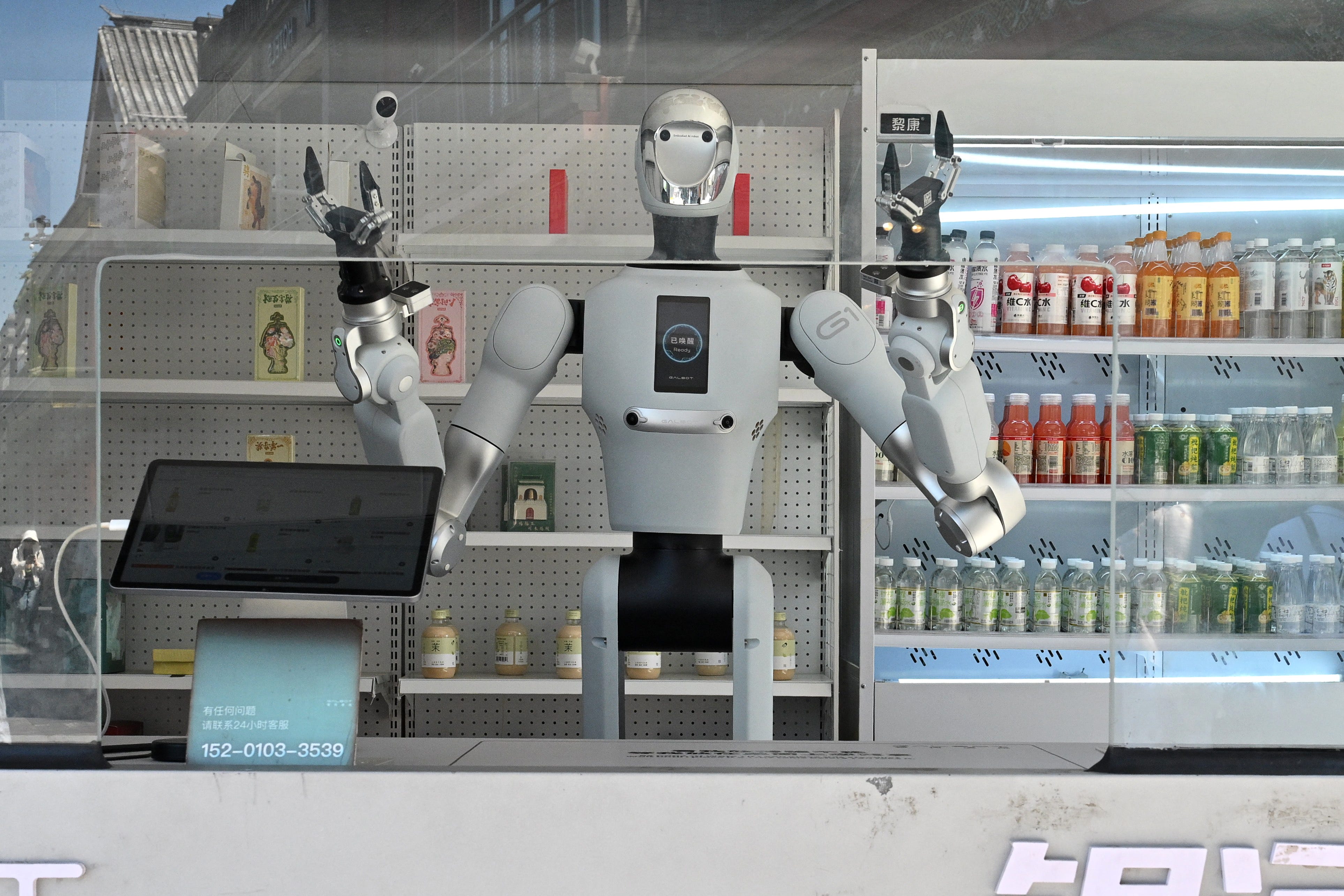 An automated robot seller gets ready to serve people at a robot kiosk in Beijing on July 17, 2026. (Photo by ADEK BERRY / AFP via Getty Images)
