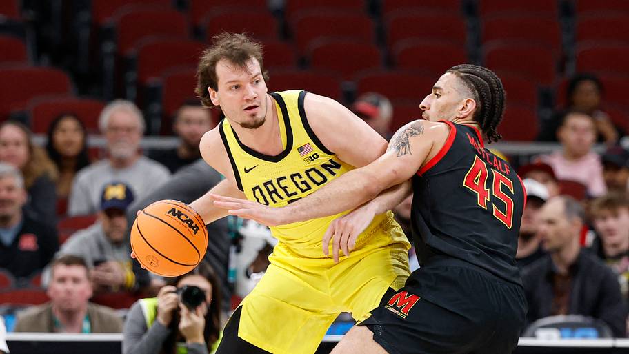 Oregon Ducks center Nate Bittle is defended by Maryland Terrapins center Collin Metcalf