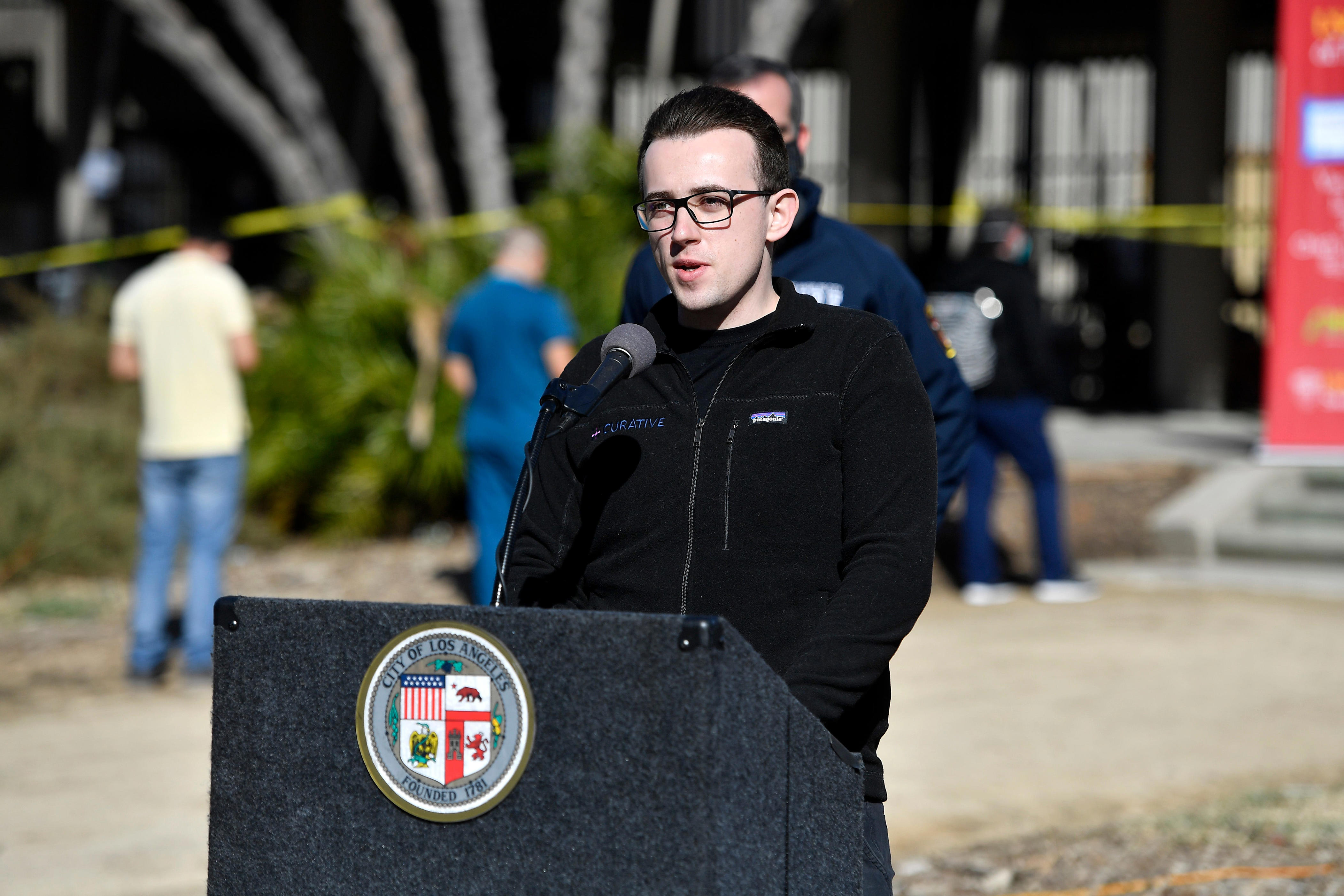Curative CEO, Fred Truner, speaks at a lectern.