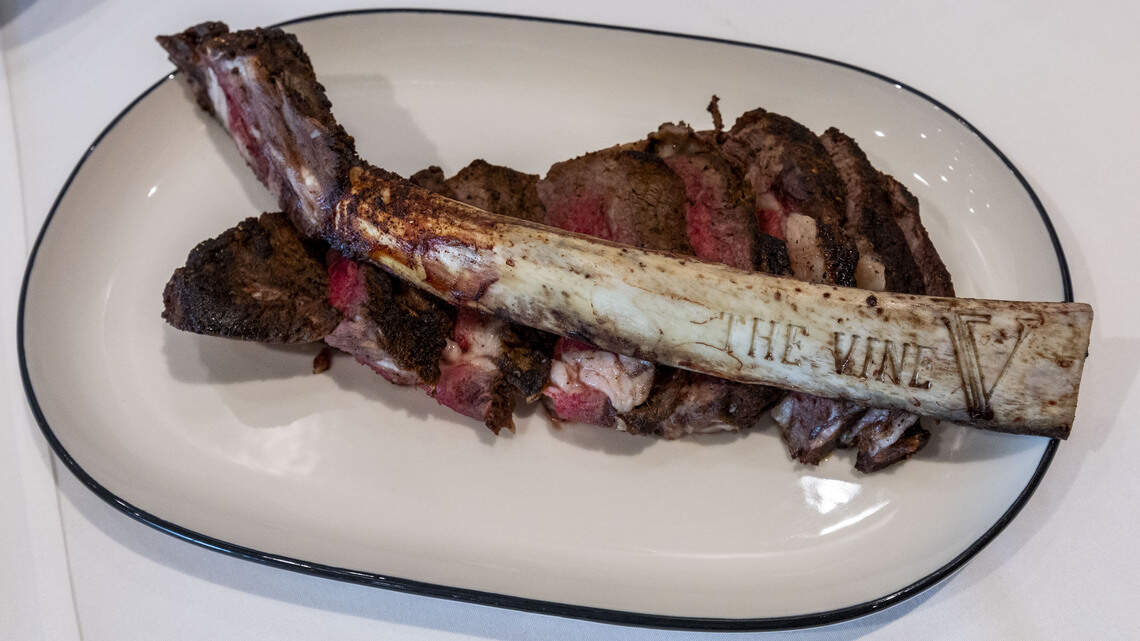 The V at the Vine has two steaks on its redesigned menu, including a 36-oz., 60 day dry-aged Tomahawk ($185) that has the name of the restaurant etched on the exposed bone.