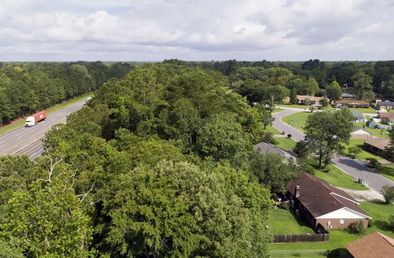 Traffic on Interstate 26 makes its way past the Northwood Estates subdivision in North Charleston, where residents have been asking for a sound wall for many years to reduce the traffic noise. File/Staff