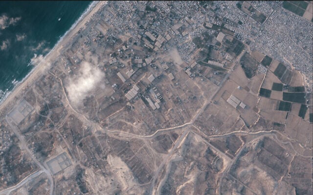 A satellite image from Planet Labs PBC shows a section of an earthen barrier, cutting horizontally across the middle of the image, being built by the Israeli military in the southern Gaza Strip, July 15, 2026. (Planet Labs PBC via AP)