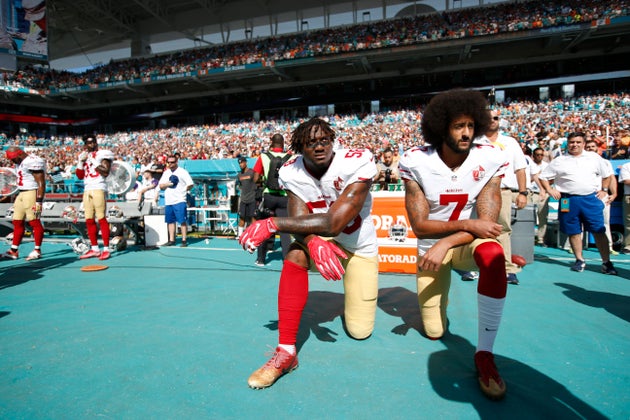 The 49ers’ Colin Kaepernick (right) and Eli Harold kneel during the anthem prior to a game against the Miami Dolphins in 2016.