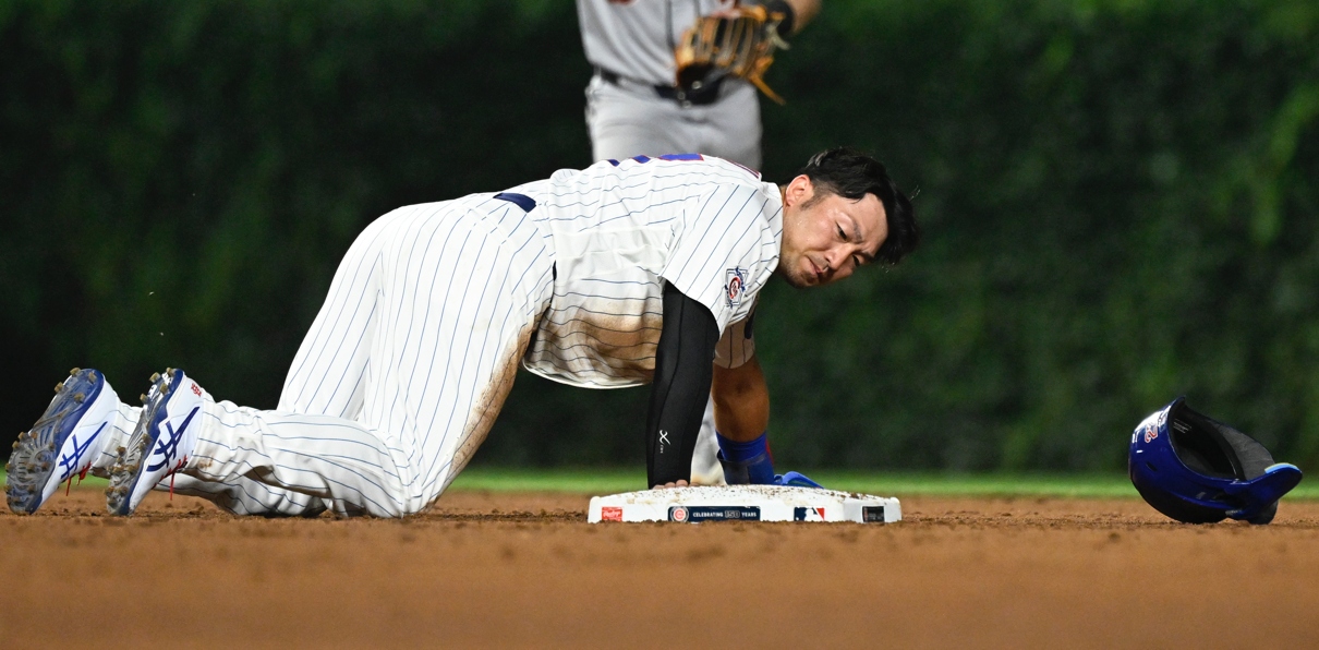 Jul 20, 2026; Chicago, Illinois, USA; Chicago Cubs right fielder Seiya Suzuki (27) loses his helmet after being picked off on a steal during the fifth inning against the Detroit Tigers at Wrigley Field. Mandatory Credit: Matt Marton-Imagn Images | Source: Matt Marton-Imagn Images