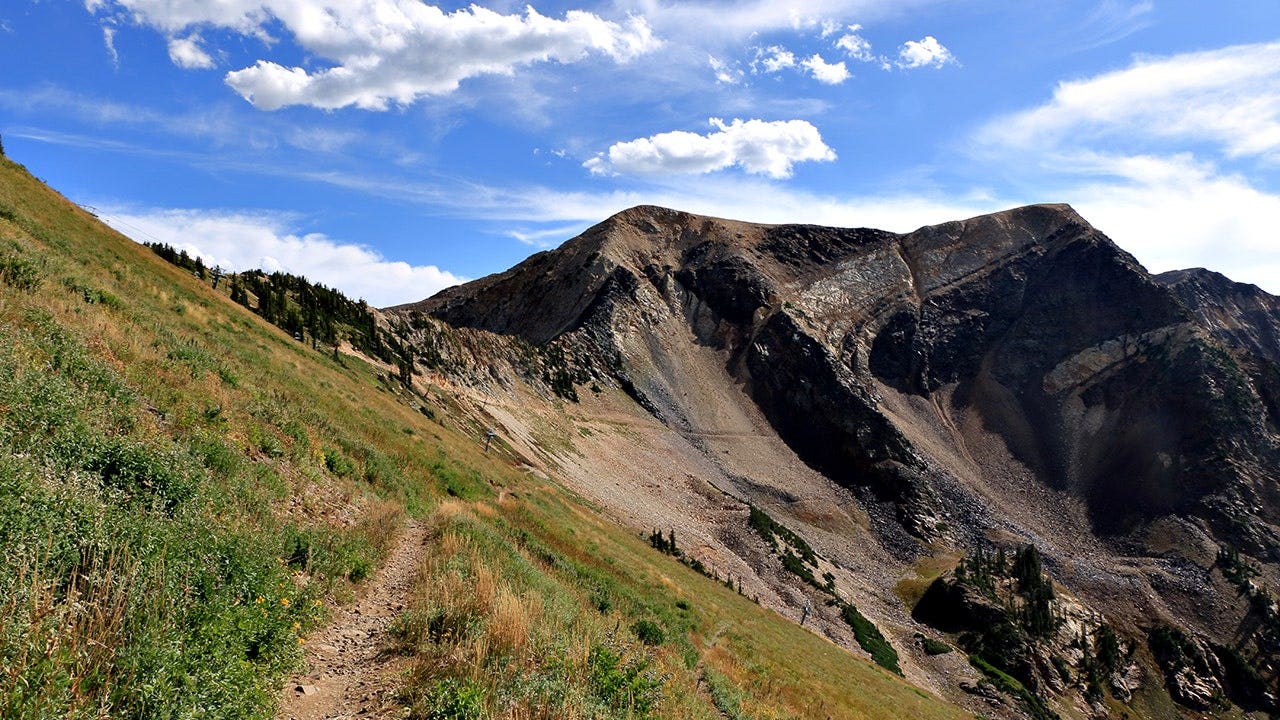 A trail leading to the barren rocky slopes of the glacial bowl beneath American Fork Twin Peaks.