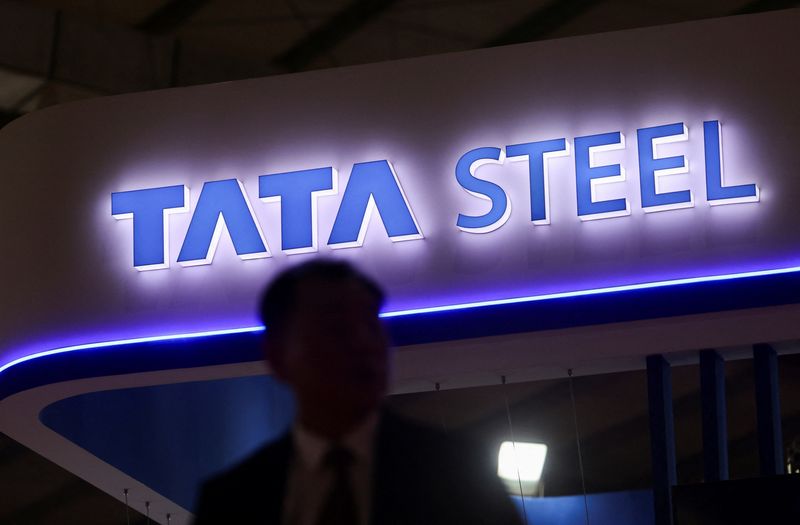 A man walks past the Tata Steel stall at the India Steel 2025 Conference in Mumbai
