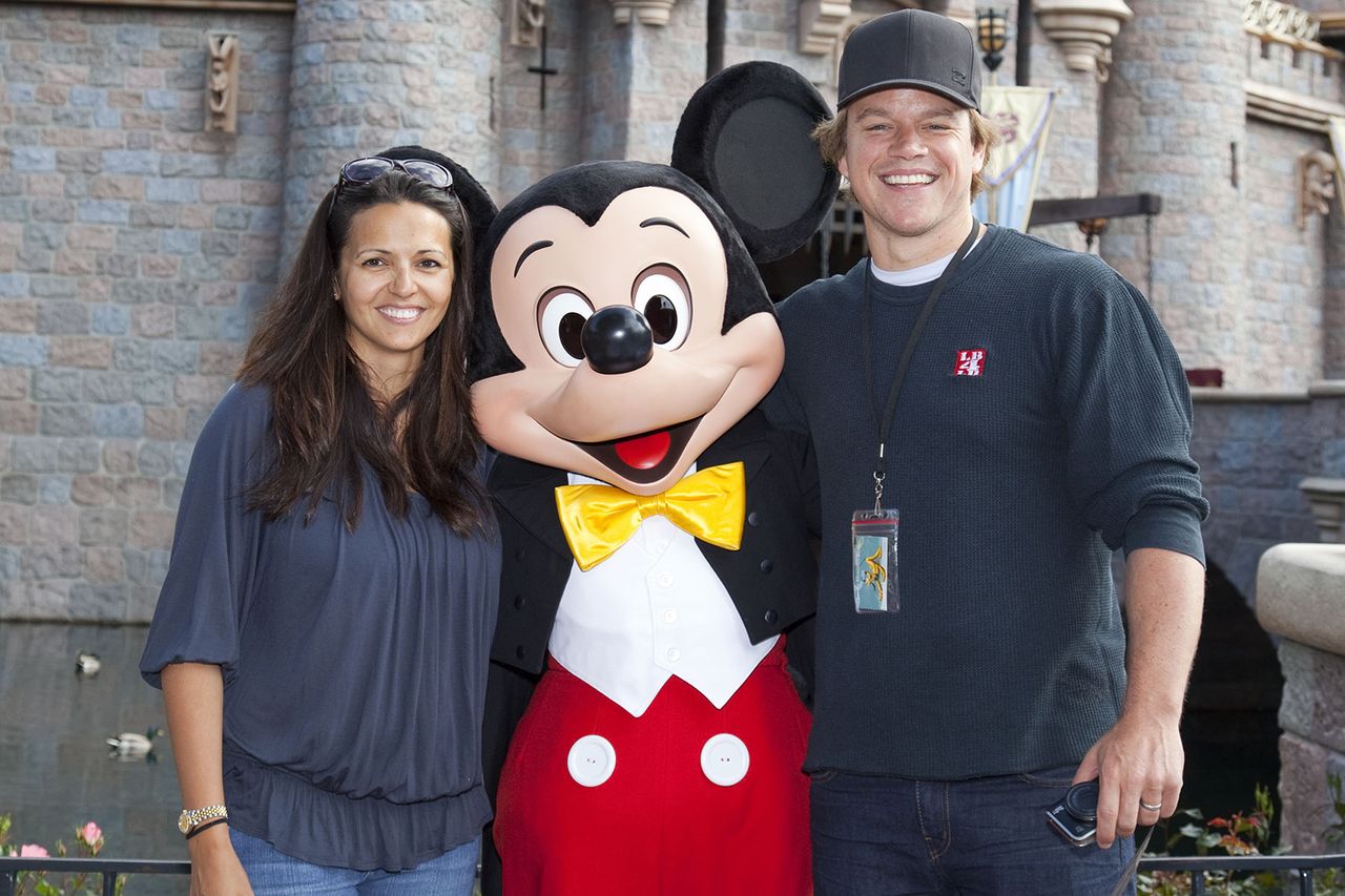In this handout photo provided by Disney Parks, actor Matt Damon and his wife Luciana pose with Mickey Mouse at Sleeping Beauty Castle at Disneyland April 22, 2011 in Anaheim, California.