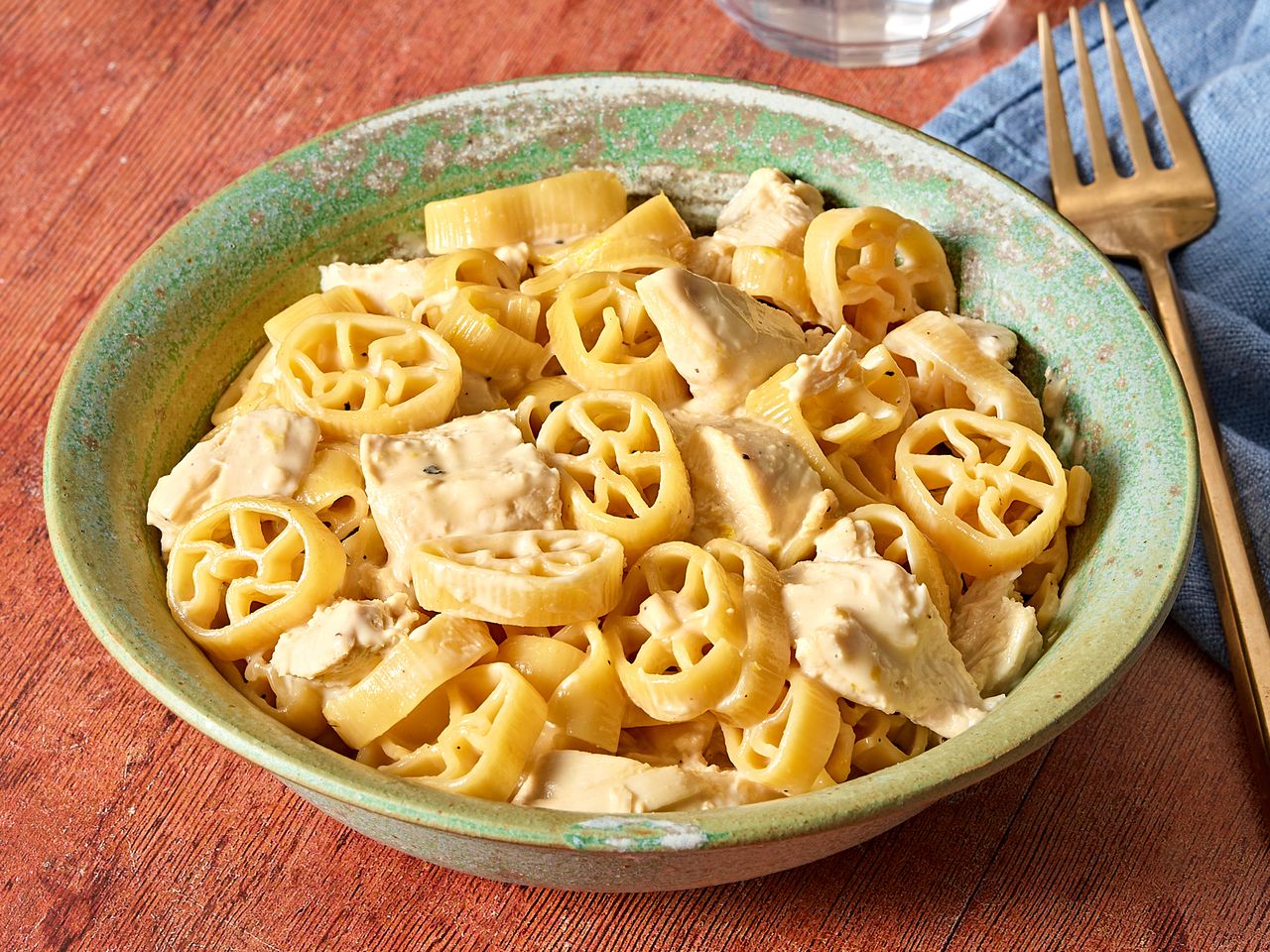 Creamy lemon chicken pasta served in a green bowl.