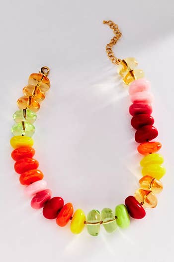Colorful glass bead necklace with adjustable gold chain. Perfect for adding a vibrant touch to any outfit