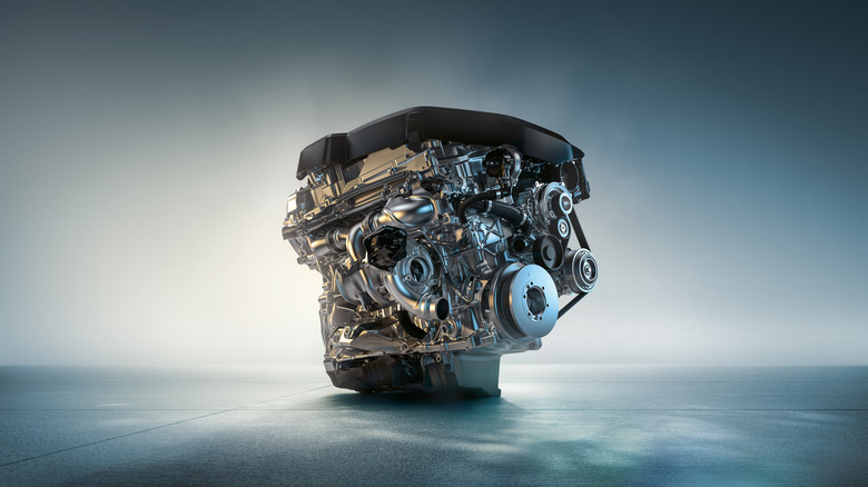 The BMW B58 engine standing against a light blue background with smoke effects surrounding the motor.