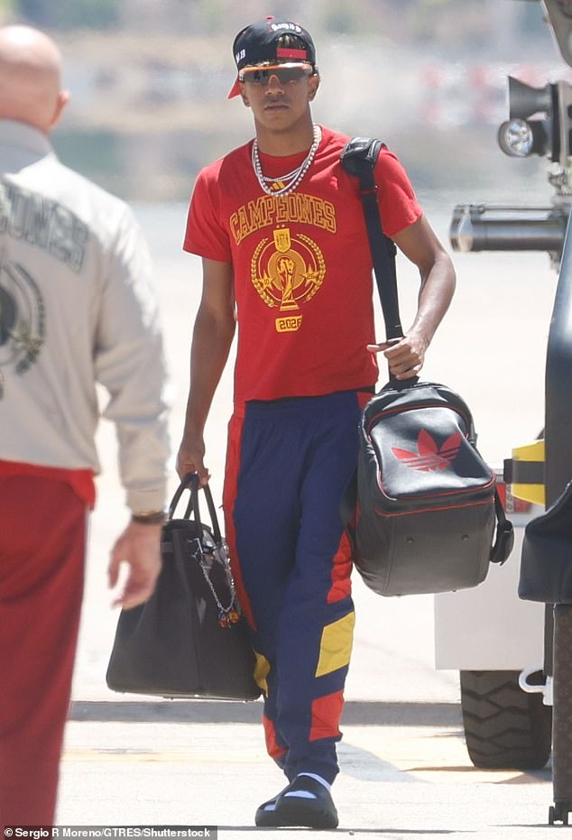 Yamal carried his bags - including an oversized Hermes Birkin sack - off the plane