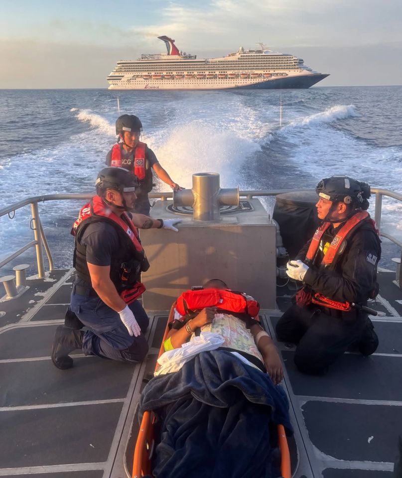 U.S. Coast Guard personnel evacuate a pregnant woman from a cruise ship off Miami after she experienced pregnancy complications just hours into a luxury Bahamas vacation