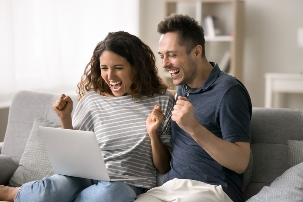couple celebrating on computer