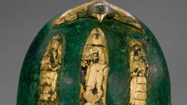 Ancient Iran helmet worn by a warrior king bears gold gods and a swooping bird of prey
