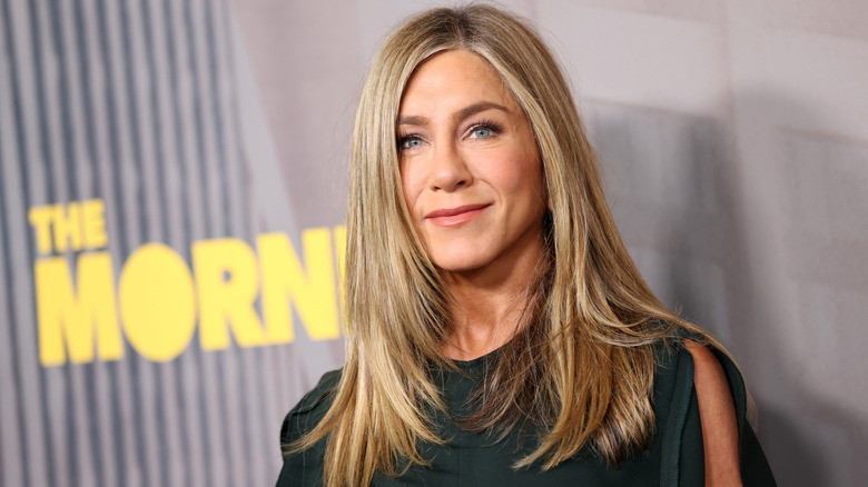 Jennifer Aniston smiles on a red carpet in 2026