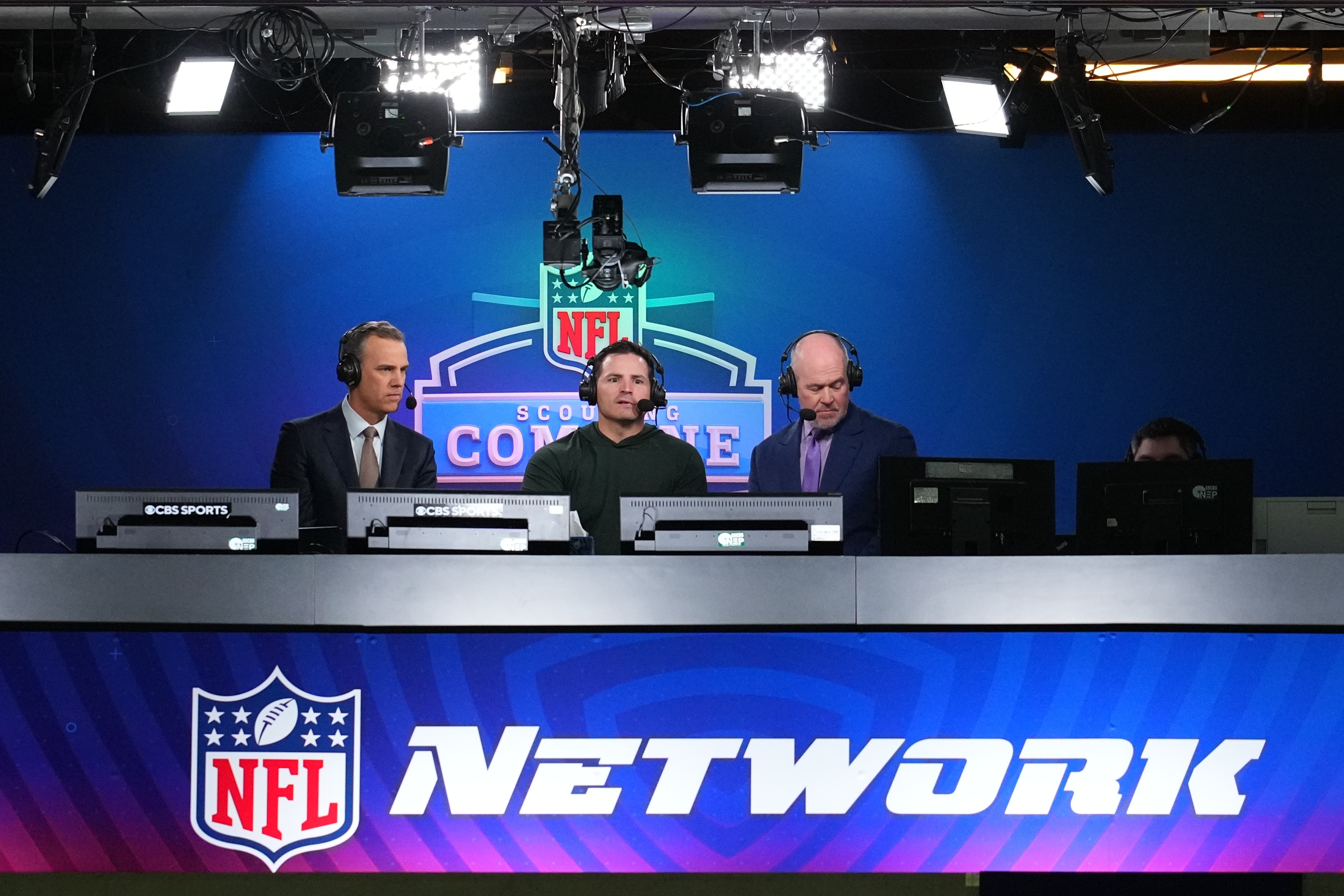 FILE - Seattle Seahawks head coach Mike Macdonald, center, talks on an NFL Network show in Indianapolis, Feb. 26, 2026. (AP Photo/Julio Cortez, File)