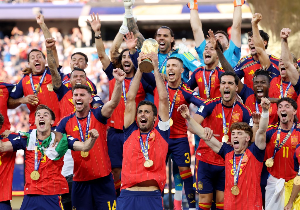 EAST RUTHERFORD, NEW JERSEY - JULY 19: Rodri #16 of Spain lifts the FIFA World Cup Winner's Trophy after the team's victory following during the FIFA World Cup 2026 Final match between Spain and Argentina at New York New Jersey Stadium on July 19, 2026 in East Rutherford, New Jersey. (Photo by Carl Recine/Getty Images)