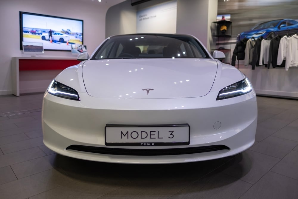 white electric Tesla car model 3 in auto store, tesla motors Elon Musk, innovative engineering, technological advancements in automotive industry in London, United Kingdom - September 17, 2024