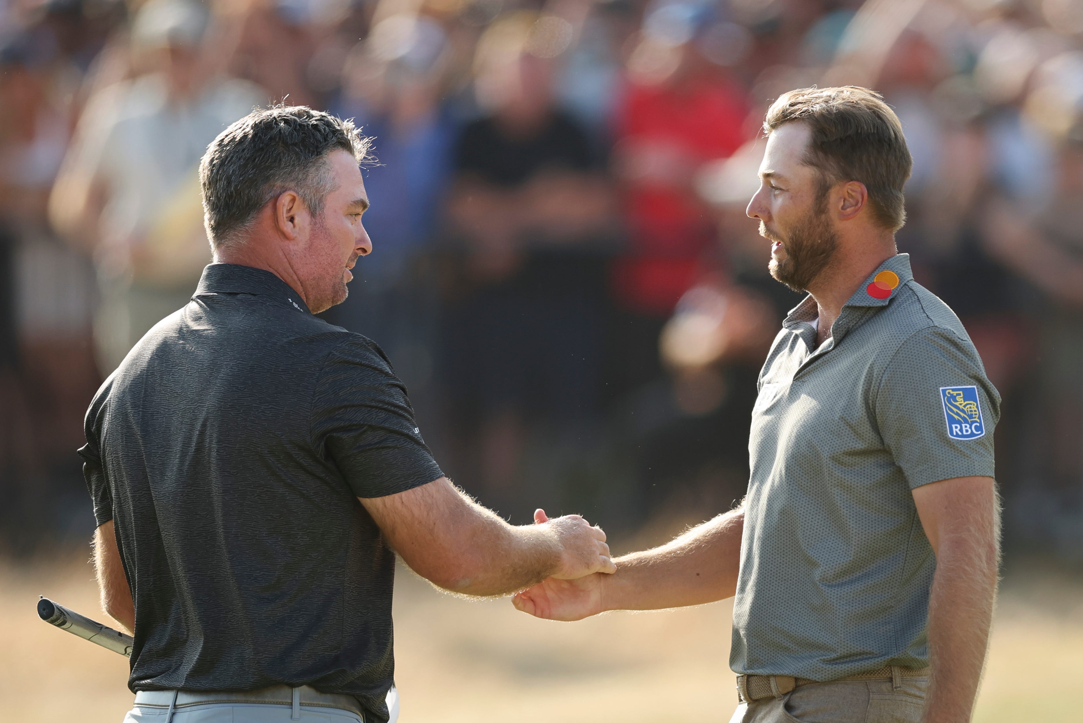 SOUTHPORT, ENGLAND - JULY 19: Ryan Fox of New Zealand is congratulated by Sam Burns of the United States after finishing their round on the 18th green on day four of the The 154th Open Championship at Royal Birkdale on July 19, 2026 in Southport, England. (Photo by Michael Reaves/Getty Images)