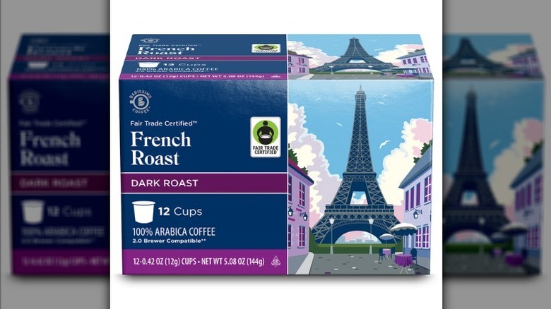 French roast coffee cups in a blue cardboard box with a drawing of the Eiffel Tower on it on a white background.