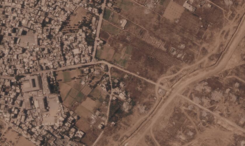 This satellite image from Planet Labs PBC shows a section of an earthen barrier being built by the Israeli military.