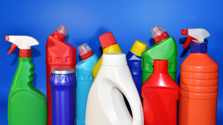 A selection of colorful household detergent bottles on a blue background