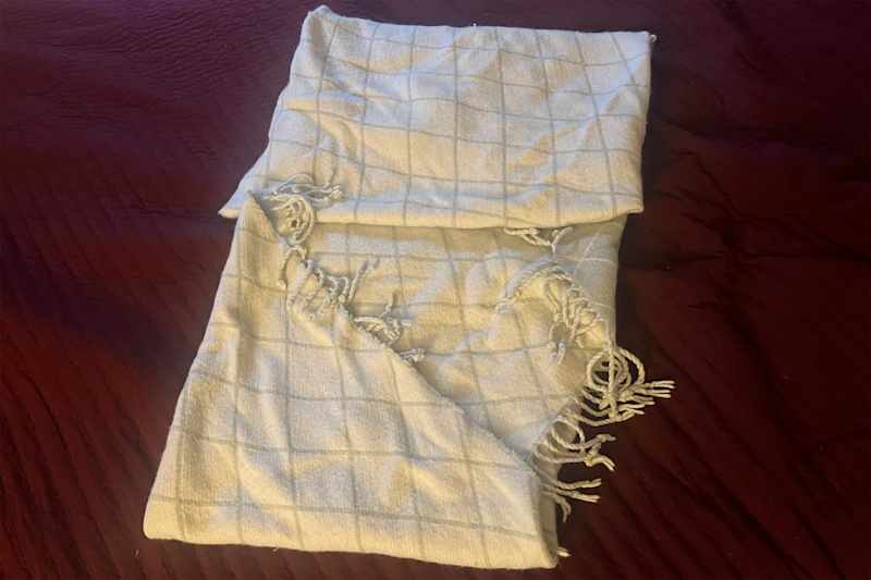 Blanket being folded.