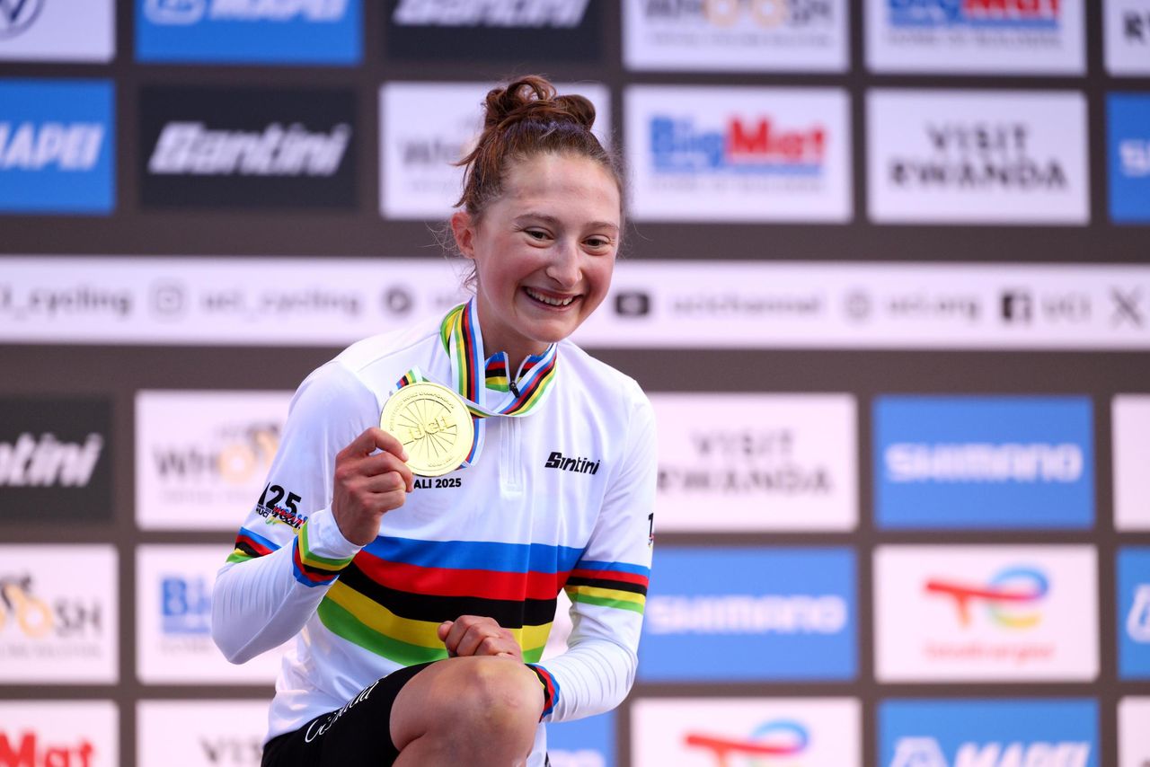 Magdeleine Vallieres poses with her gold medal after winning the World Championships road race in 2025