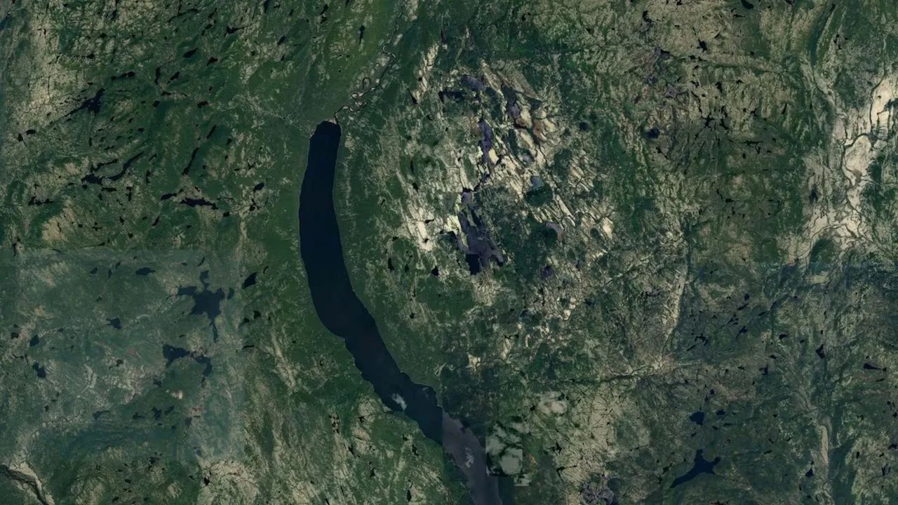 a large circular depression seen on a satellite photo of a green area on earth