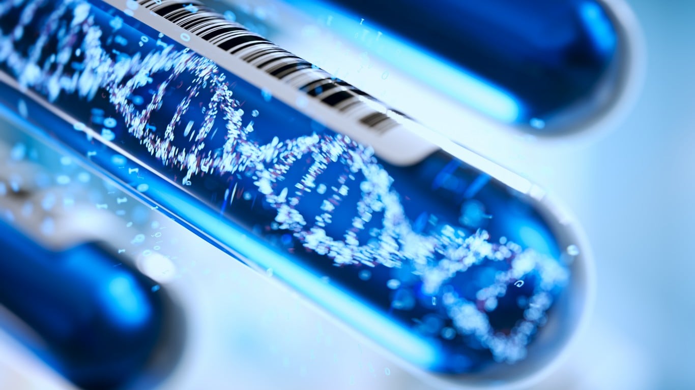 A scientific image featuring several blue-lit test tubes, with the central vial prominently displaying a glowing, abstract DNA double helix structure made of many bright particles. The test tube also has a barcode on its label, and other blurred blue tubes and scattered glowing numbers are visible in the background, set against a soft blue backdrop.