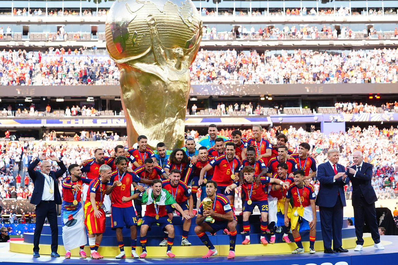 Rodri of Spain celebrates by lifting the FIFA World Cup trophy with teammates
