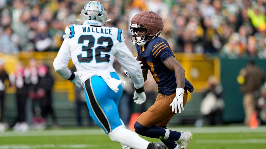 Green Bay Packers wide receiver Romeo Doubs (87) runs after a catch against Carolina Panthers linebacker Trevin Wallace
