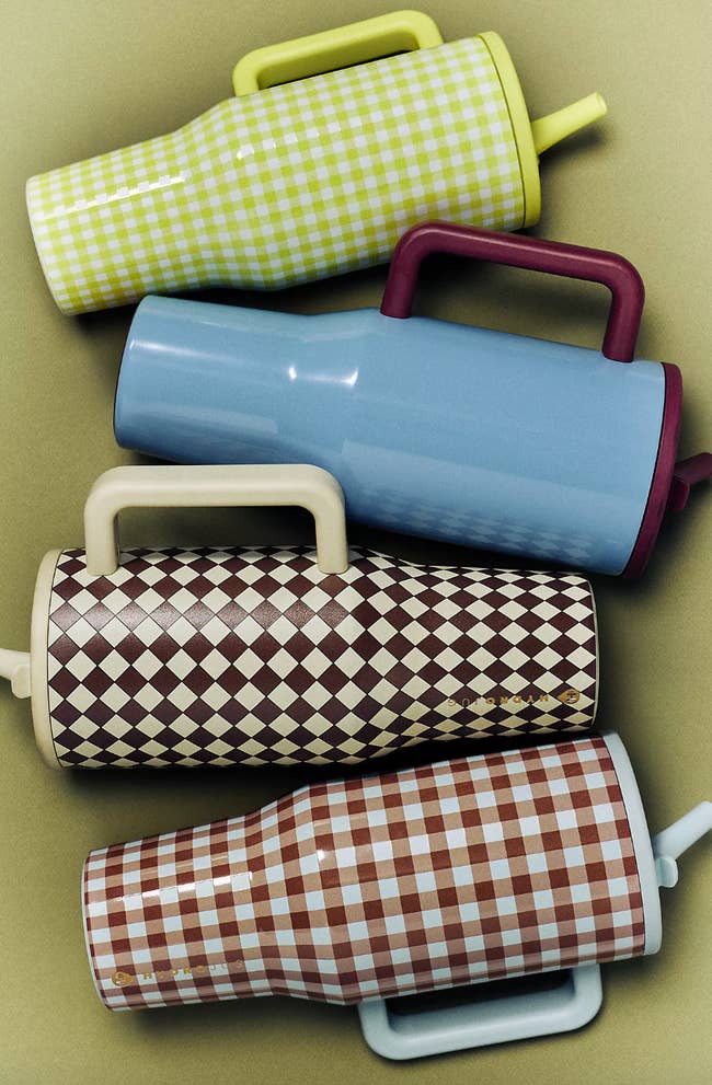 Four stylish insulated tumblers with various checkered and diamond patterns, ideal for shopping or gifting