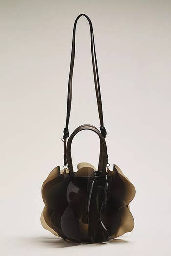 Stylish handbag with a unique, wavy design and long strap, ideal for making a fashion statement