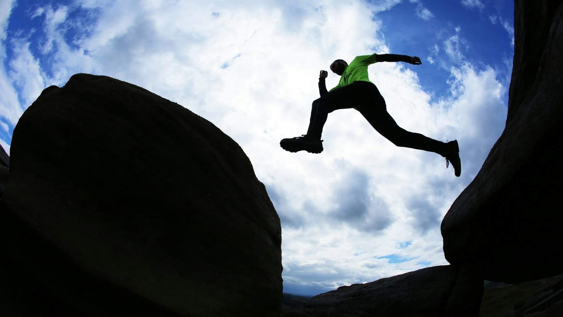Runner jumping from one rock to another