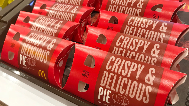Rows of McDonald's apple pies in red cardboard sleeves