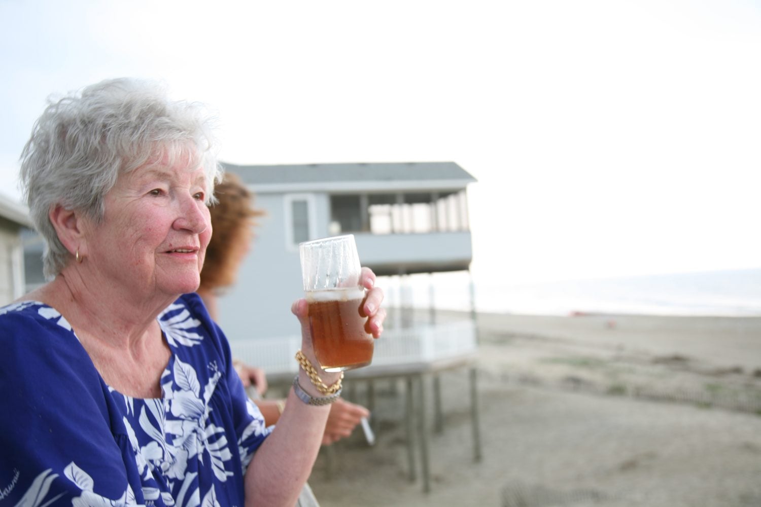 Attractive senior female thinking while looking out over the beach
