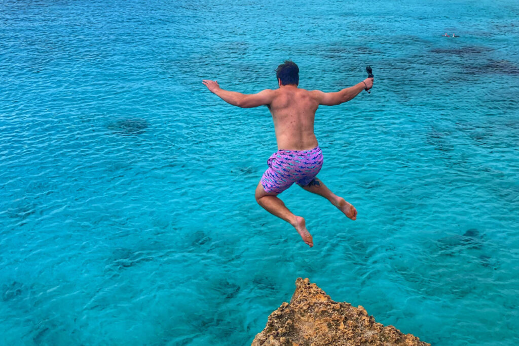 Tyler Fox jumping off cliff at Boca Slagbaai in Bonaire