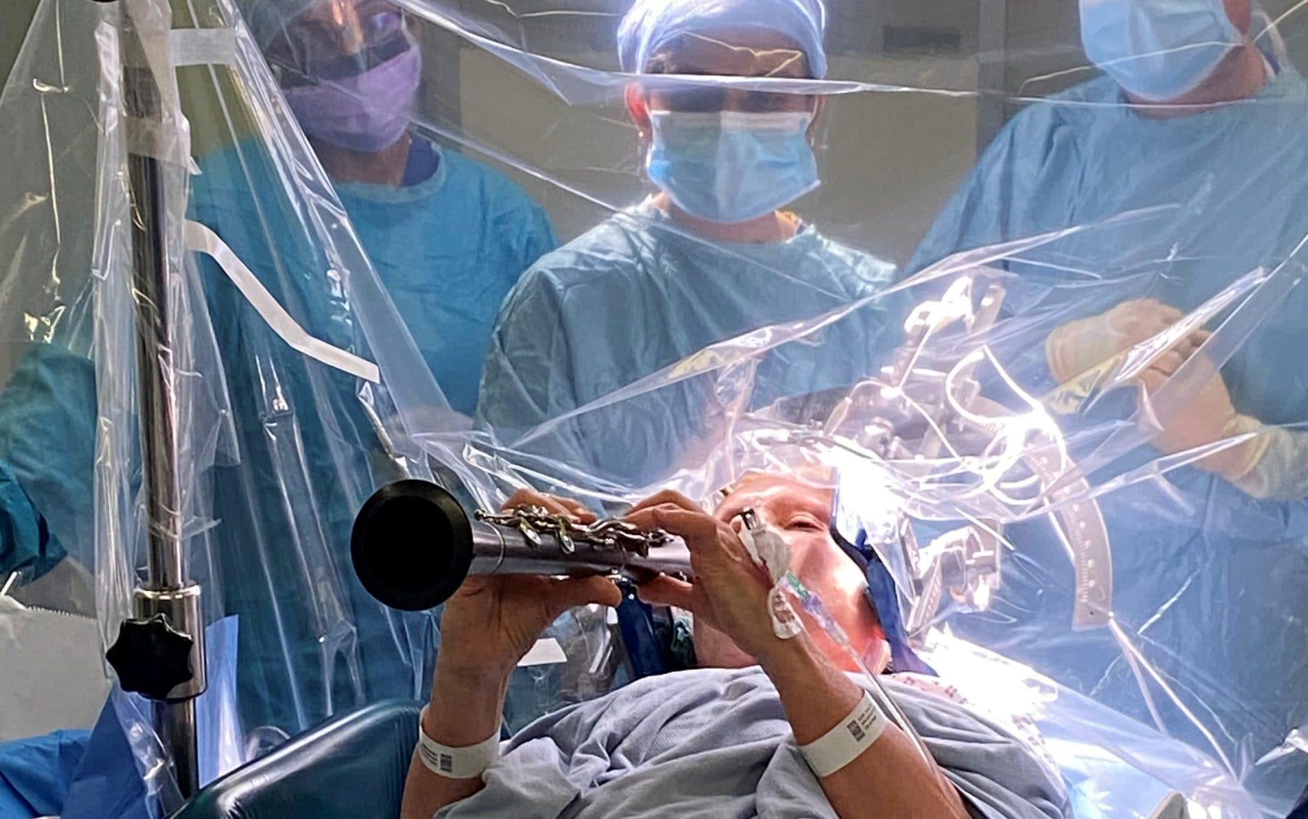 Patient playing the clarinet whilst being operated on